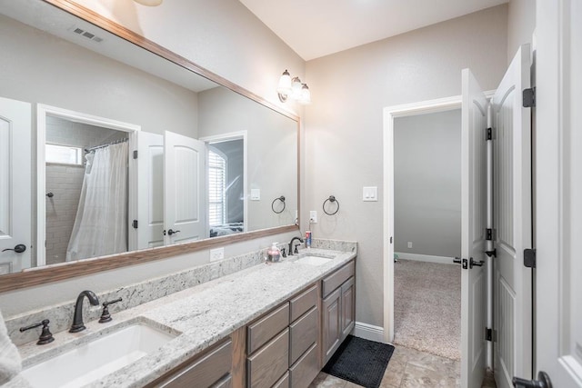 7604 Keyhaven St, Odessa, TX 79765 - bathroom with double vanity and a shower with curtain