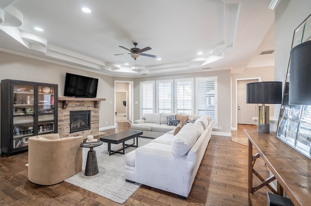 7604 Keyhaven St, Odessa, TX 79765 - living area with a fireplace, a ceiling fan, a raised ceiling, recessed lighting, and ornamental molding