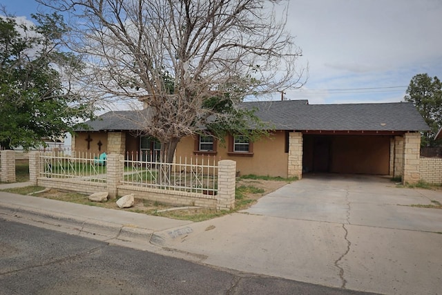 1642 S Plum Ave, Pecos, TX 79772 - ranch-style home featuring a fenced front yard, concrete driveway, a shingled roof, an attached carport, and stucco siding