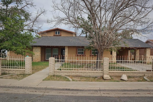 1642 S Plum Ave, Pecos, TX 79772 - view of front of property with a fenced front yard, a shingled roof, and stucco siding