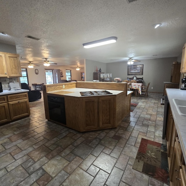 9935 W Yukon Rd, Odessa, TX 79764 - kitchen featuring ceiling fan, a textured ceiling, stone tile flooring, electric cooktop, and light countertops