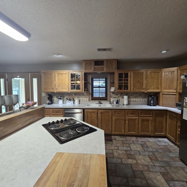 9935 W Yukon Rd, Odessa, TX 79764 - kitchen with light countertops, black electric stovetop, decorative backsplash, a textured ceiling, and recessed lighting