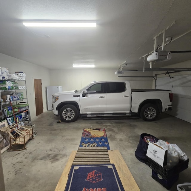 9935 W Yukon Rd, Odessa, TX 79764 - garage with a garage door opener and refrigerator