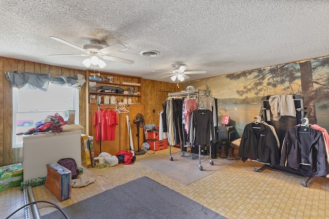 1908 W 36th St, Monahans, TX 79756 - misc room with a ceiling fan, wood walls, and a textured ceiling