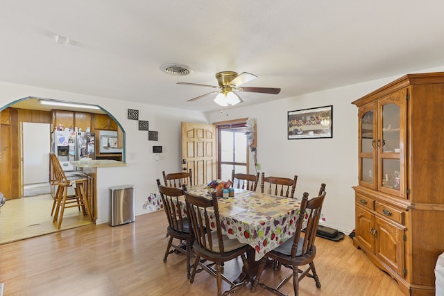 1908 W 36th St, Monahans, TX 79756 - dining room featuring arched walkways, a ceiling fan, light wood finished floors, and baseboards