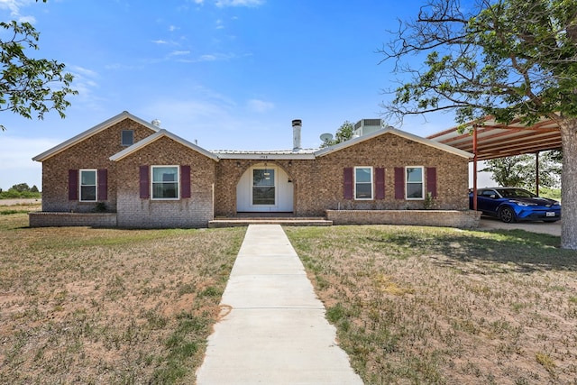 1908 W 36th St, Monahans, TX 79756 - ranch-style house with brick siding, a front yard, and a carport