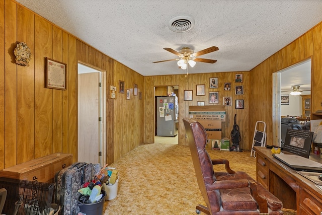 1908 W 36th St, Monahans, TX 79756 - carpeted office space with ceiling fan, wood walls, and a textured ceiling