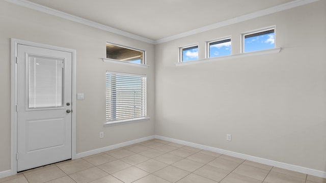 unfurnished room with crown molding, plenty of natural light, and light tile patterned floors