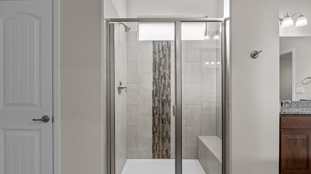 bathroom featuring vanity and an enclosed shower