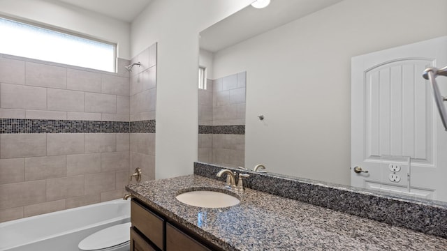 full bathroom featuring vanity, toilet, and tiled shower / bath