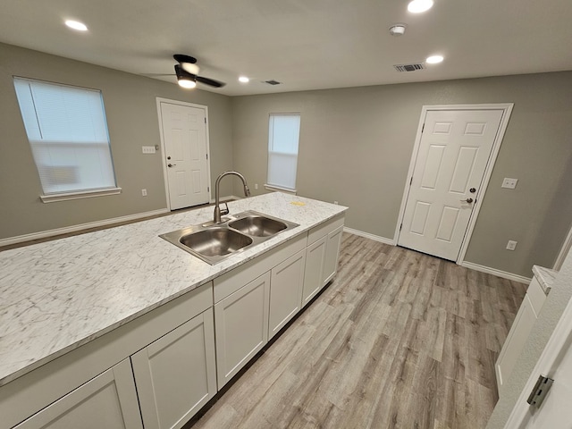 3819 Robertson Ave, Odessa, TX 79764 - kitchen featuring ceiling fan, light wood finished floors, light countertops, white cabinetry, and recessed lighting