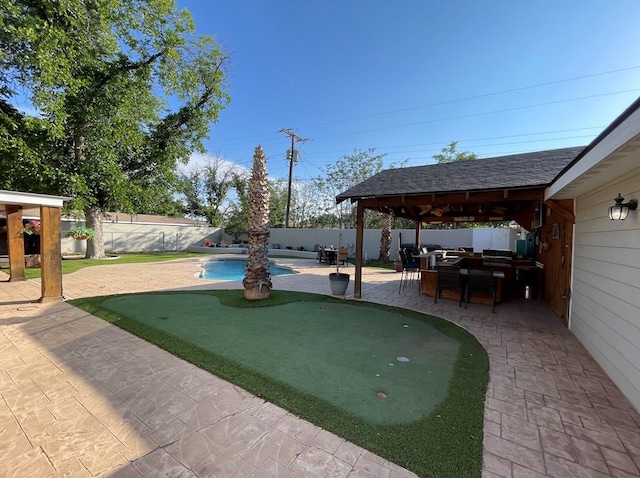 1401 S Franklin Ave, Monahans, TX 79756 - fenced backyard with a putting area, a gazebo, a patio, and an outdoor hangout area