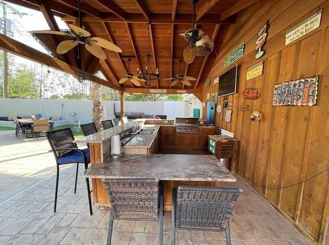 1401 S Franklin Ave, Monahans, TX 79756 - fenced backyard featuring an outdoor kitchen, ceiling fan, and a patio