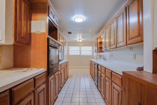 2802 Windsor Dr, Odessa, TX 79762 - kitchen featuring oven, brown cabinets, light countertops, and light tile patterned flooring