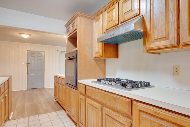2802 Windsor Dr, Odessa, TX 79762 - kitchen featuring under cabinet range hood, stainless steel gas cooktop, oven, light countertops, and light wood-type flooring