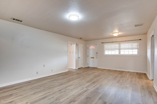 2802 Windsor Dr, Odessa, TX 79762 - unfurnished room with light wood-style floors, baseboards, and a textured ceiling