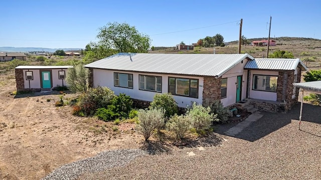 504 San Juan Dr, Fort Davis, TX 79734 - single story home featuring stone siding, a metal roof, and stucco siding