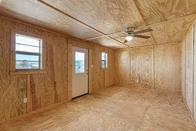 504 San Juan Dr, Fort Davis, TX 79734 - unfurnished room with plenty of natural light, wooden walls, and a ceiling fan