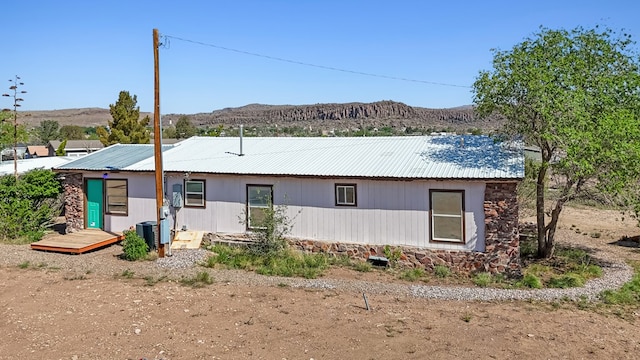 504 San Juan Dr, Fort Davis, TX 79734 - view of front of property featuring a metal roof, stone siding, and a deck with mountain view