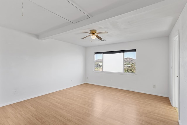 504 San Juan Dr, Fort Davis, TX 79734 - empty room with light wood-style floors, beam ceiling, ceiling fan, and attic access