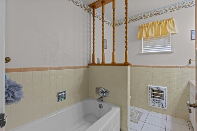 full bathroom with heating unit, tile walls, a garden tub, tile patterned floors, and wainscoting