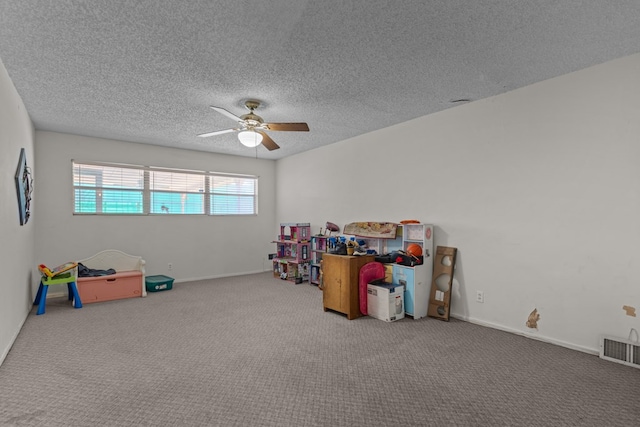 rec room with ceiling fan, carpet flooring, a textured ceiling, and baseboards