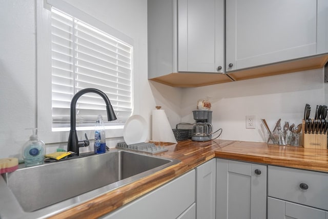 411 N San Jacinto St, Odessa, TX 79762 - kitchen with butcher block counters and white cabinetry