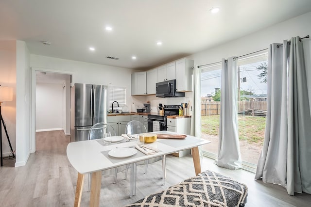 411 N San Jacinto St, Odessa, TX 79762 - kitchen featuring black appliances, light wood-type flooring, and recessed lighting