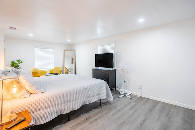 411 N San Jacinto St, Odessa, TX 79762 - bedroom featuring wood finished floors, recessed lighting, and multiple windows
