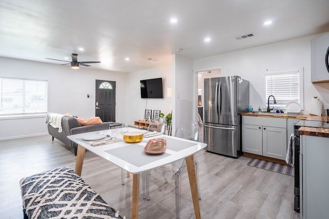 411 N San Jacinto St, Odessa, TX 79762 - kitchen with freestanding refrigerator, butcher block countertops, range with electric cooktop, light wood-style floors, and recessed lighting