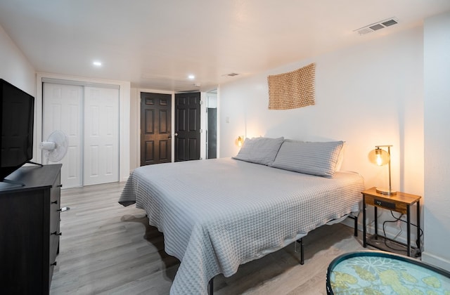 411 N San Jacinto St, Odessa, TX 79762 - bedroom featuring wood finished floors, two closets, and recessed lighting