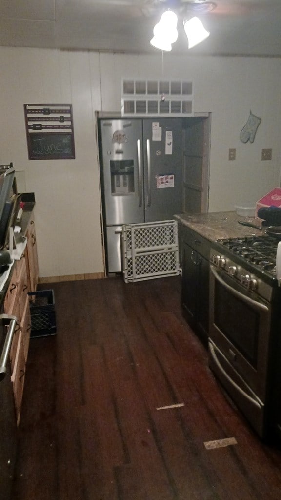 302 E 67th St, Odessa, TX 79762 - kitchen with appliances with stainless steel finishes, dark wood-style flooring, and ceiling fan