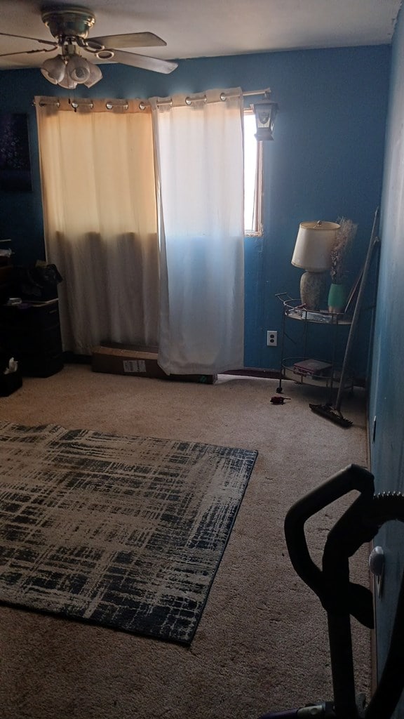 302 E 67th St, Odessa, TX 79762 - living area with carpet floors and a ceiling fan