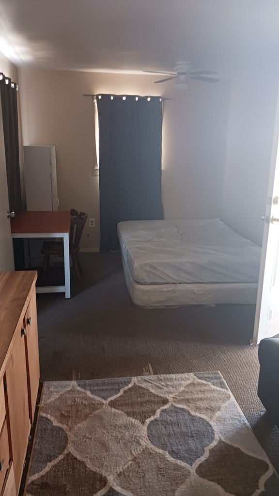 302 E 67th St, Odessa, TX 79762 - bedroom with carpet flooring and baseboards