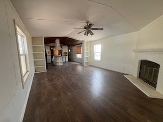 7720 W 26th St, Odessa, TX 79764 - unfurnished living room featuring a ceiling fan, a glass covered fireplace, wood finished floors, lofted ceiling, and built in features