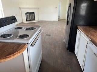 7720 W 26th St, Odessa, TX 79764 - kitchen featuring white appliances, white cabinets, a glass covered fireplace, and dark wood-style flooring