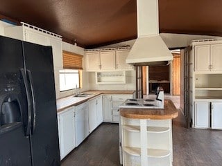 7720 W 26th St, Odessa, TX 79764 - kitchen with black fridge with ice dispenser, vaulted ceiling, island exhaust hood, white cabinetry, and a sink