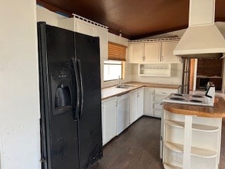 7720 W 26th St, Odessa, TX 79764 - kitchen with black fridge, custom exhaust hood, white dishwasher, a sink, and white cabinetry