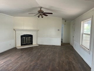 7720 W 26th St, Odessa, TX 79764 - unfurnished living room with ceiling fan, wood finished floors, a glass covered fireplace, and vaulted ceiling