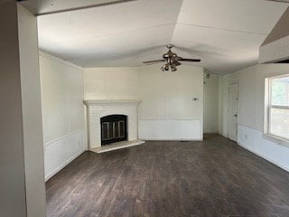 7720 W 26th St, Odessa, TX 79764 - unfurnished living room with lofted ceiling, ceiling fan, a glass covered fireplace, and wood finished floors