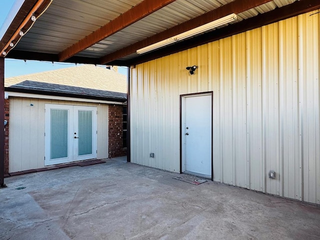 exterior space with french doors, a patio, and a shingled roof