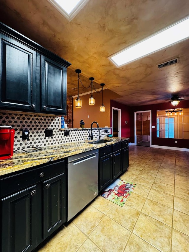 kitchen featuring visible vents, light tile patterned floors, a peninsula, dark cabinetry, and stainless steel dishwasher