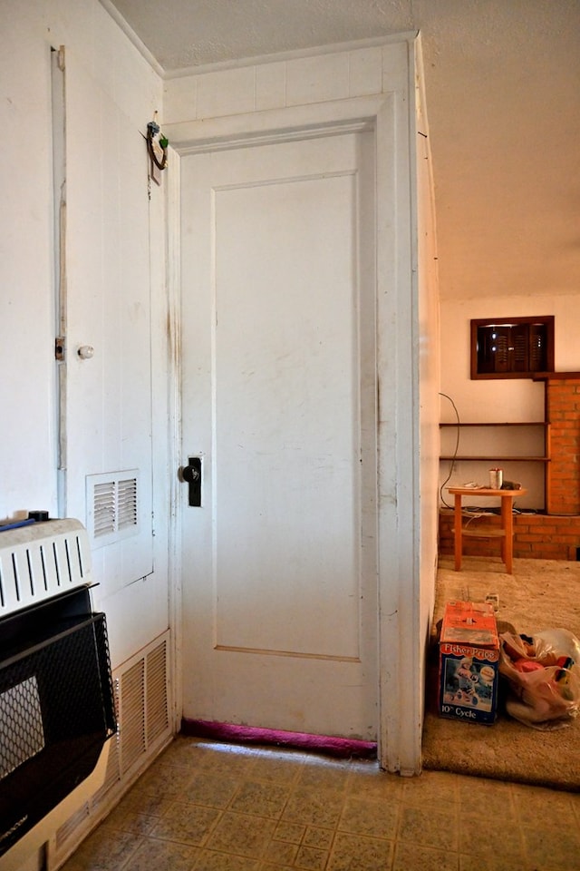 entryway with heating unit and tile patterned floors