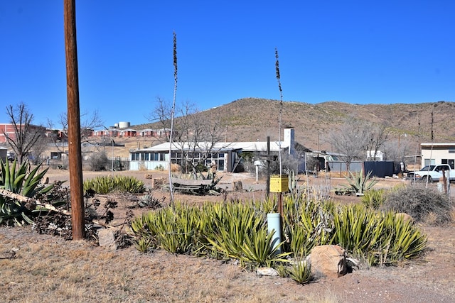 exterior space featuring fence and a mountain view