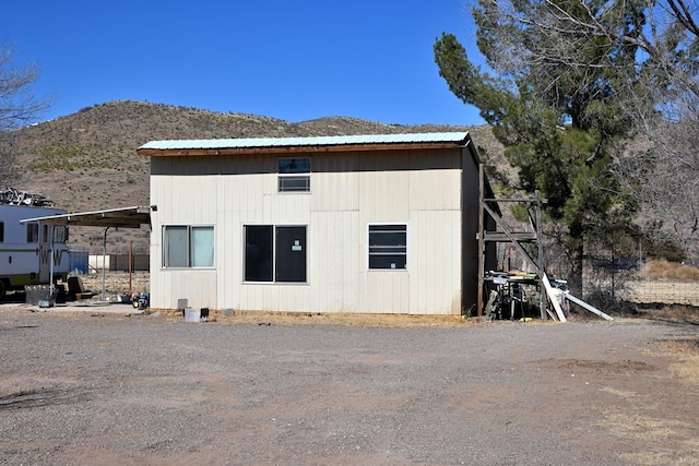 rear view of property featuring a mountain view and metal roof