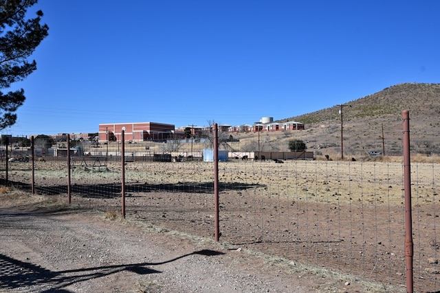 view of yard with fence and a mountain view