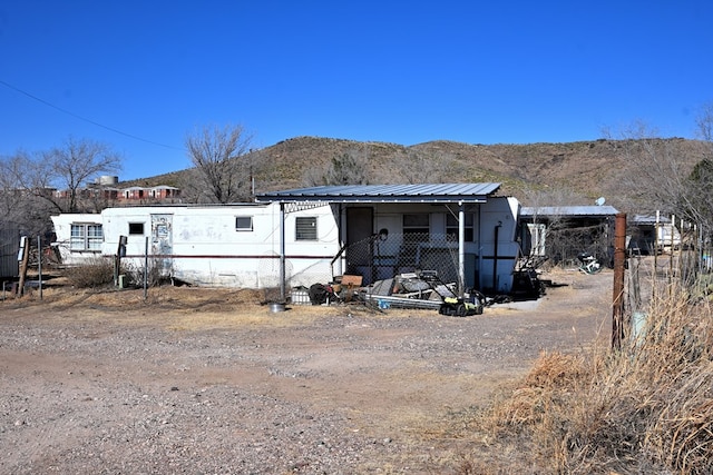 view of front of house with a mountain view and metal roof