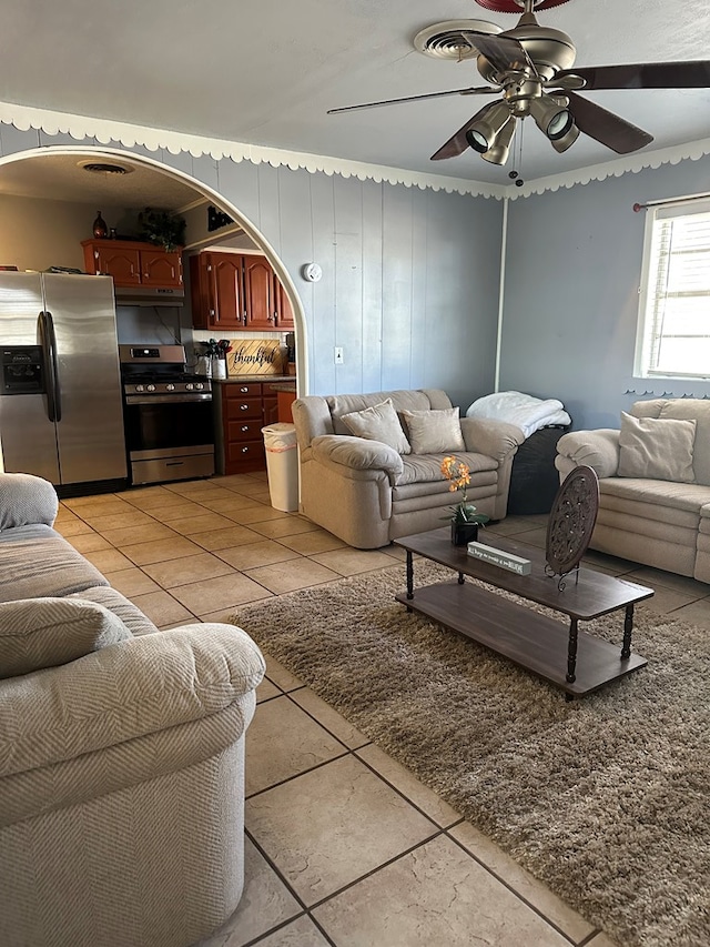 1001 Dorothea St, Crane, TX 79731 - living area featuring arched walkways, a ceiling fan, and light tile patterned floors