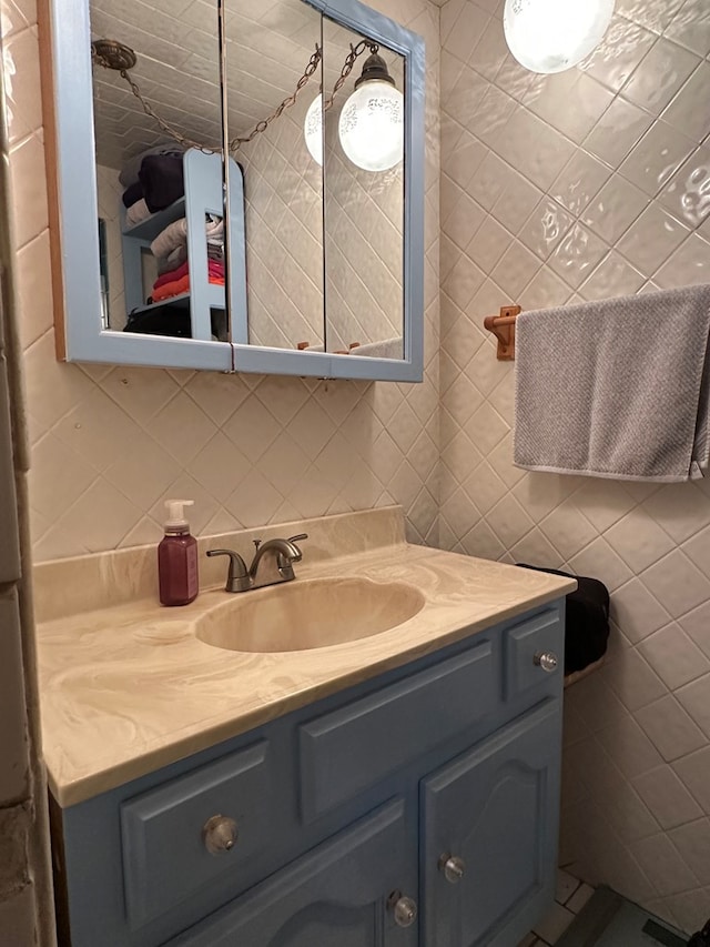 1001 Dorothea St, Crane, TX 79731 - bathroom featuring tile walls, vanity, and decorative backsplash