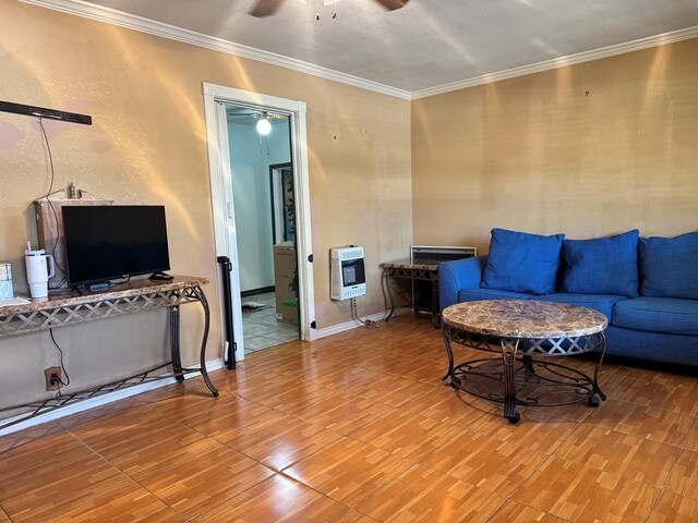 807 NW 5th St, Andrews, TX 79714 - living area with heating unit, a ceiling fan, wood finished floors, ornamental molding, and baseboards